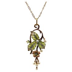 A classic Art Nouveau design, this 15k rose gold necklace features stunning plique-à-jour, Rose Cut diamonds, and beautiful pearls. The centerpiece of the necklace is articulated, hinged in two places so that the flower and pearl drops dangle freely. Three plique-à-jour leaves are translucent—the loveliest matte soft green that fades into subtle purple highlights, clearly done by a master. Each cell of the leaf is filled with plique, with a white metal (platinum or white gold) creating contrast in the center of the leaf. Inside are a channel of bead set Rose Cut diamonds. A flower is suspended from the leaves, with multi-tones of peach to pale yellow that glow against the gold, with a prong-set diamond as its piston. The design work loops over, turning the bail into a scrolling foliate. Th Designer Pendant Sets, Subtle Purple Highlights, Diamond And Pearl Necklace, Bijoux Art Nouveau, Purple Highlights, Art Nouveau Design, Bead Set, Art Deco Era, Gold Art