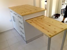 a kitchen island made out of plywood and metal legs with drawers on each side