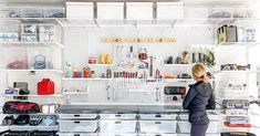 a woman standing in front of a garage shelving unit