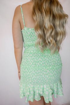 This mint green floral smocked dress features a ruffled hem and adjustable straps. The model is wearing a size small. Smocked Dress, The Model, Mint Green, Clothes For Sale, Sofia, Smocking, Halter Dress, Crochet Top, Adjustable Straps