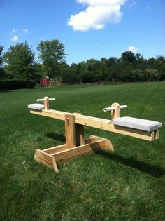 two wooden benches sitting on top of a lush green field