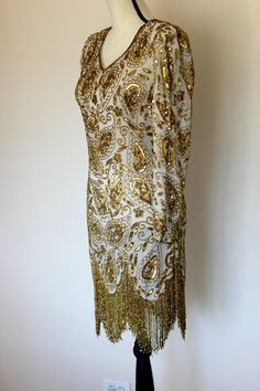 "Beautiful Gunit Flapper Dress with Gold beads and sequins throughout. Excellent condition! Long flowy gold beaded fringe. This one is a true head turner!! Zipper in the back Measuring: 36\" long 34\" bust 28\" waist 34\" hip 23\" sleeve Beautiful! in every way!! Pet free/ smoke free Enjoy!" Beaded Formal Dress, Vintage Formal Dresses, Gatsby Party, Beaded Fringe, Dress Vintage, Gatsby, Gold Beads, Formal Dress, Flapper Dress