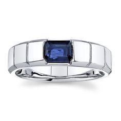 a white gold ring with a blue sapphire stone