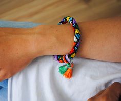 a woman's arm with a colorful bracelet on it