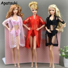 three barbie dolls standing next to each other