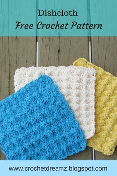 three crocheted dishcloths sitting on top of a wooden table