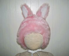 The bright and cheery pink bunny hat will fit 18.5-20" heads (toddler to 4 years old child)  Perfect gift for a boy or girl! This bubblegum pink bunny hat is so cute with nice stand-up ears and ties to keep it near.... It is offered for Halloween costuming or everyday wear, role play or dress up fun.   It has been developed from a vintage 60's patternI added some fun baby bunny earsall the better to hear you with, my dears!! ;0) And they stay standing at attention.  This is completely lined in soft cotton gingham, so it is light enough to wear for sprint or fall festivities. MORE HATS HERE  I have oodles of fun and one of a kind hats for costuming, winter and your pleasure!!  See them all here  https://www.etsy.com/shop/avantegarb?ref=seller-platform-mcnav&section_id=31237388 Each one of m Baby Bunny Hat, Vegan Halloween, Baby Rabbit, Bunny Hat, Fun Baby, Pink Bunny, Baby Bunny, Pink Faux Fur, Motif Vintage