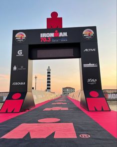 the iron man race finish line is decorated with pink and black colors for runners to walk on