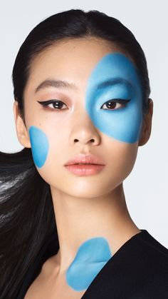 a woman with blue paint on her face