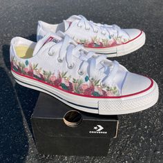 "These White Slip On Vans have an adorable and sweet flower design.  These are the perfect and comfortable gift for wearing on the big day while also enjoying them after the fact while out for brunch and reminiscing on saying \"I Do\". These shoes are also perfect for your wedding party's flower girl, ring bearer, brides maids, etc. We buy each pair of shoes BRAND NEW. Each pair is made to order, please make sure you put in the correct shoe size before you check out. The ink is permanent and will never come off, fade away, or peel off. Made in the USA. This price includes everything: shoes, artwork, and shipping. Thanks for stopping by our Etsy shop! Please message me with any questions! Because the artwork is custom made for you, there are no exchanges or returns. If you have any issues w Spring Wedding Shoes With Flower Design, Spring Wedding Shoes With Round Toe For Bridal Shower, Spring Wedding Shoes For Bridal Shower, Spring Bridal Shower Wedding Shoes With Round Toe, Spring Wedding Sneakers With Round Toe, Summer White Lace-up Wedding Shoes, White Lace-up Summer Wedding Shoes, White Lace-up Wedding Shoes For Summer, White Wedding Sneakers For Summer