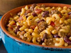 a bowl filled with macaroni and beans on top of a table