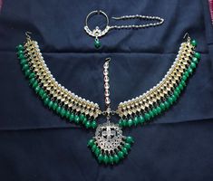 a green and white necklace with matching earrings