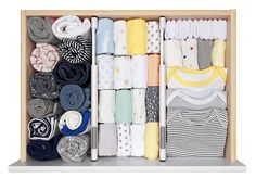 an open drawer filled with lots of different types of shirts and ties on it's sides