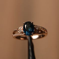 a close up of a ring with a blue stone