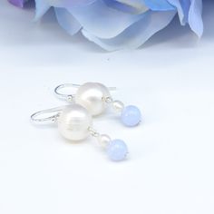 "Blue and white! Beautiful fresh colours. Large 10mm white round pearl with striations, 2mm white seed pearl, and beautiful blue 6mm round lace agate. Simple, delicate. From the pierce it is 1.5\" with a 1\" drop." Elegant White Round Bead Earrings, White Drop Pearl Earrings For Anniversary, Anniversary White Drop Pearl Earrings, Blue Teardrop Pearl Drop Earrings, Classic Blue Round Pearl Earrings, Blue Drop Pearl Earrings With Pearl Charm, White Baroque Pearl Earrings, Blue Round Pearl Earrings For Anniversary, Blue Pearl Drop Earrings For Anniversary