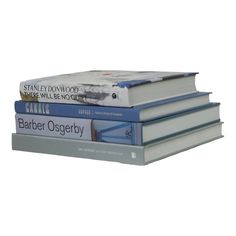 three books stacked on top of each other, one is blue and the other is white