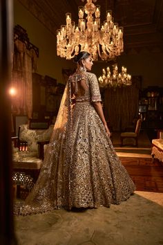 This lehenga set features heavy antique gold embroidery interspersed with bold cut work. The lehenga is further lined with antique gold crush tissue. The blouse shows exaggerated pearl tassels at the sleeve hem, elbow and at the back of the blouse. it is paired with a matching heavy embroidered with tassels on all four sidesFrom Seema Gujral's Falaknuma collection. DELIVERY TIMEPlease allow 8-12 weeks for your outfit to arrive. FABRIC DETAILSNet Professional cleaning only. Indian Reception Outfit Bridal, Indian Reception Outfit, Pearl Tassels, Work Lehenga, Party Wear Indian Dresses, Gold Embroidery, 12 Weeks, Professional Cleaning, Bridal Lehenga