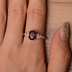 It is natural garnet ring. The main stone is 7mm*9 mm oval cut.weight about 2.33 carats. The basic metal is sterling silver and plated with rhodium. To change the metal to a solid gold (white/rose) or platinum is also available, please ask for a quotation if you want. You can also go to my shop Home for more elegant rings: https://www.etsy.com/shop/godjewelry?ref=hdr_shop_menu Emerald is January birthstone More garnet rings: https://www.etsy.com/shop/godjewelry?ref=l2-shopheader-name§ion_id=2070 Oval Garnet Birthstone Ring, Elegant Oval Garnet Birthstone Ring, Silver Oval Garnet Birthstone Ring, Oval Silver Garnet Birthstone Ring, Oval Garnet Birthstone Ring In Silver, Oval Garnet Birthstone Ring As Gift, Oval Garnet Birthstone Ring For Anniversary, Oval Cabochon Garnet Jewelry For Anniversary, Anniversary Garnet Oval Cabochon Jewelry