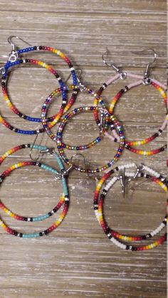 Native American seed bead hoop earrings. The multi colored random mix hoops are 2 1/4 inches in length including earwire. The blue, pink, turquoise, and white with the ombre pattern are 2 1/2 inches in length including earwire. All have surgical steel earwires. Multicolor Hoop Earrings With Ear Wire, Nickel Free Multicolor Beaded Bracelets, Nickel-free Multicolor Beaded Bracelets, Multicolor Hoop Beaded Earrings With Spacer Beads, Multicolor Beaded Hoop Earrings With Spacer Beads, Multicolor Hoop Jewelry With Spacer Beads, Multicolor Small Hoop Jewelry With Spacer Beads, Adjustable Multicolor Earrings With Spacer Beads, Multicolor Tiny Beads Hoop Earrings For Festival