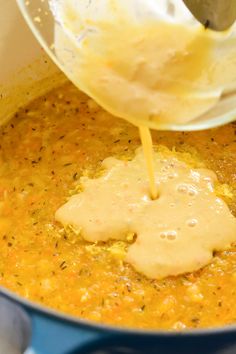 the sauce is being poured over the food in the pot to make it look like it has been cooked