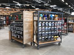 the inside of a store with several shelves filled with bottles and cans on wheels,