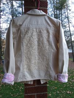 This short, khaki jacket is made by Denim & Co. It is embellished with a hand made, crocheted applique; hand-stitched on the back.  The tag says extra small, but Denim & Co runs big, so it fits like a small. Pit to Pit measurement is 19.5 inches, so bust measurement would be 39. It is 21 inches long. 100% lightweight cotton denim. Pink trim at the inside back neck and cuffs. Beautiful, professionally done, quality seams. Perfect for a young girl. Long Sleeve Cotton Outerwear With Lace Trim, Cotton Long Sleeve Outerwear With Lace Trim, Fitted Crochet Cotton Outerwear, Off White Jacket, Khaki Jeans, Khaki Jacket, Pink Trim, Lightweight Shorts, Crochet Applique