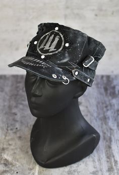 This pretty unisex headpiece is based off a retro toque's pattern. It's sewn by hand from waterproof fabric, with leather straps and other decorative details. It would be a great addition to any post-apocalyptic costume, or a unique piece of your everyday clothing. Height of the toque: 10cm / 3,94 in We have a toque in stock that fits a head circumference of 52-53cm / 20.5-21in, ready to ship in 1-3 days. We will prepare a toque for a different head circumference from scratch. For a perfectly fitted cap please provide your measurement head circumference. All of our clothes are handmade, which is why individual pieces may slightly differ from those shown in the photos. If you can't find your size or would like to customize this product according to your preferences, please don't hesitate to Vintage Black Hat For Alternative Fashion, Vintage Black Hats For Alternative Fashion, Fitted Punk Hats For Cosplay, Black Punk Hat For Cosplay, Black Steampunk Hat For Alternative Fashion, Punk Style Adjustable Costume Hats For Cosplay, Adjustable Punk Costume Hats And Headpieces For Cosplay, Alternative Style Adjustable Cap, Black Alternative Style Hats For Alternative Fashion