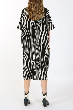 Zebra printed fabric Standard collar Button down Shirt dress Midi length Relaxed fit Imported 100% POLYESTER Model is 5 ft 10 in. Wearing a Small Caring for your clothes is caring for the environmentWash your clothes with lower temperature and delicate spin cycles. It helps to maintain the color, shape and structure of the fabric. At the same time it reduces energy consumption that is used in care processes. ONE SIZE ME3037_BLACK_ALL Black Midi Dress With Graphic Print, Black Short Sleeve Printed Midi Dress, Spring Graphic Print Workwear Dresses, Spring Graphic Print Work Dresses, Spring Workwear Dresses With Graphic Print, Oversized Printed Black Dresses, Printed Black Dress For Work, Oversized Black Printed Dress, Black Printed Dress For Work