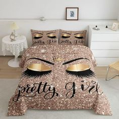 a bed with gold glitter eyes and eyelashes on it