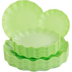 green dishes stacked on top of each other in different shapes and sizes with wavy designs