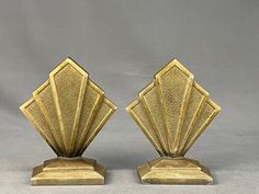 pair of art deco bookends in brass metal with geometric design on each side