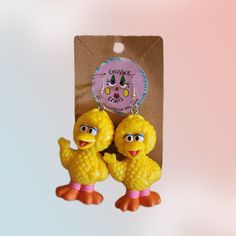 two yellow birds are hanging from a brown package