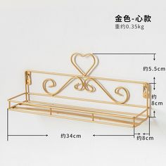 a gold metal shelf with a heart on it and measurements for the top section,