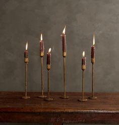 five candles are lined up on a table