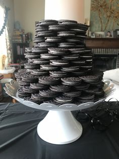 a large stack of cookies sitting on top of a cake plate