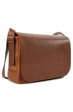 Work smart with this sleek messenger bag that holds your laptop and career essentials. It's crafted from rich leather that looks even better over time. Magnetic closure Padded compartment fits most 15" laptops Adjustable crossbody strap Leather card pocket; 2 interior slide pockets; 2 interior slide pockets Leather Imported Brown Crossbody Laptop Bag For Business, Business Crossbody Satchel With Smooth Grain, Business Satchel With Smooth Grain Crossbody, Classic Leather Crossbody Laptop Bag, Timeless Brown Saddle Bag For Business, Formal Brown Crossbody Laptop Bag, Business Crossbody Flap Bag With Smooth Grain, Classic Crossbody Laptop Bag With Sleeve, Modern Brown Flap Bag For Travel