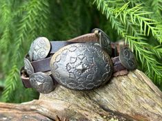 This vintage Navajo belt features 20 mini sterling conchos, each with the same design, on a brown leather belt. Each concho can be adjusted along the belt, so that the wearer can switch up the spacing if they desire. "Concho" refers to the round discs of silver on the belt. Unstamped and unsigned, this belt was sterling silver tested.  The belt measures 33 1/2 inches long by 1 inch wide. The buckle by itself measures 2 1/4 inches long by 1 5/8 inches wide.  Everything is shipped with signature requirement for the safety of your purchase! Navajo Belt, Sterling Brown, Concho Belt, Brown Leather Belt, Vintage Navajo, Suspender Belt, Leather Mini, Leather Belt, Belts