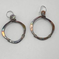 "These bronze earrings are hammered and given a patina finish for a rustic look. Mixed metal of bronze and sterling silver have a nice two tone effect. These earrings are very rustic and earthy and make a unique statement. They measure 1 3/4\" Long. Approximate measurements without an ear wire attached: 1 1/8\" widest part x 1 5/16\"high -(29mm widest part x 33mm High). These are also available in a larger version-see link below. The patina effect gives these earthy earrings lots of color. Every Handmade Drop Wrap Earrings For Everyday, Small Hoop Single Wrap Earring Gift, Metal Hoop Earrings As Gift, Artisan Hand Forged Earrings, Nickel-free Small Hoop Metal Earrings, Unique Metal Hoop Earrings As Gift, Hoop Earrings In Metal As Gift, Unique Small Hoop Metal Earrings, Unique Handmade Small Hoop Jewelry