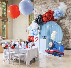 a thomas the train birthday party with balloons