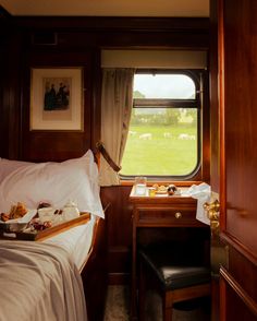 a bed sitting next to a window in a bedroom