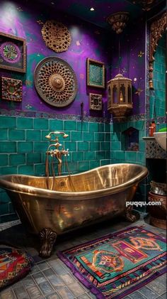 a bathroom with a gold bathtub, rugs and pictures on the wall above it