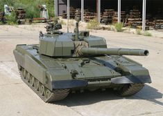 an army tank sitting on top of a parking lot