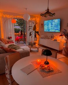 a living room filled with furniture and a flat screen tv mounted to the side of a wall