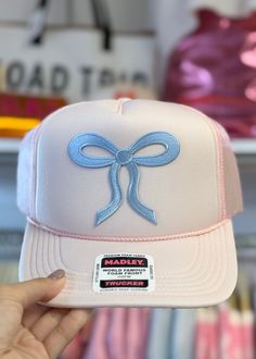 Get ready to turn heads with our Cutesie Pink & Blue Bow Trucker Hat! The trending bow pattern adds a touch of whimsy to this light pink trucker hat, accented with baby blue stitching. Made by Hats by Madley, this hat is perfect for anyone looking to add a playful and unique touch to their outfit. Pink Trucker Hat, Bow Pattern, Teacher Style, Blue Bow, Red Star, Makeup Bags Travel, Sneaker Heels, Sales Gifts, Baby Blue