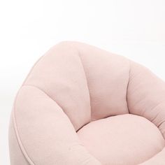 a pink chair sitting on top of a white floor