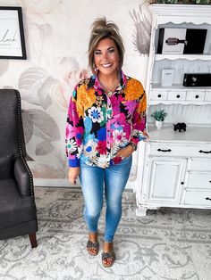 This floral blouse is ready to brighten your day and your wardrobe. Bursting with a colorful collage of flowers and geometric shapes, its lightweight woven fabric and ruched shoulders make it perfect for tropical destinations or just dreaming of them. Flirty shirring details and a button front add feminine flair, while its collared neckline maintains a polished profile. Equal parts playful and posh, this top is ideal for both work and weekend. Slip it on with crisp trousers or your favorite dist Spring Long Sleeve Blouse With Floral Patchwork, Long Sleeve Blouse With Floral Patchwork For Spring, Patterned Blouse With Bold Print, Colorful Floral Print Fall Blouse, Colorful Floral Print Long Sleeve Tops, Trendy Patterned Blouse With Vibrant Print, Vacation Floral Print Long Sleeve Blouse, Multicolor Floral Print Long Sleeve Tops, Long Sleeve Floral Print Blouse For Vacation