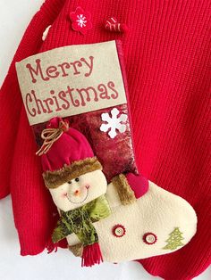 a christmas stocking with two snowmen on it and a sign that says merry christmas