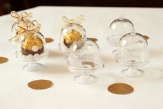 three clear glass vases with gold decorations on them