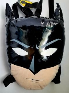 Brand New With Tag; Never Used. Pillow Has Backpack Straps, And A Zippered Pouch. Approximately 15 Inches (L) X 12 Inches (W). Perfect To Pack Pajamas Into And Take To Grandma's For The Weekend, Or Sleepovers. Reflection In Picture Makes It Appear As There Are Scuffs In Batman's Eyes, And Discoloration, But There Is Not. Comes From A Smoke-Free Home. Themed Black School Backpack, Themed Black Backpack For School, Black Novelty Standard Backpack, Novelty Black Standard Backpack, Novelty Black Backpack For Everyday Use, Black Character Backpack For Everyday Use, Novelty Black Backpack, Novelty Black School Bag, Playful Black Bag For Back To School