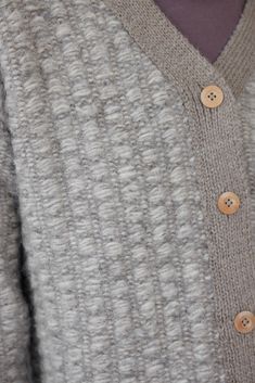 handloomed sweater jacket in a super soft and lofty double layer stitch. tonal edges, high v-neck with wood buttons and a rolled hem. the double layer knit/weave technique creates and intricate pattern with the fuzzy, bulkier yarn peeking through the tonal alpaca yarn and makes for a substantial and warm layer. 70% alpaca, 30% pima cotton. deigned in philadelphia, handloomed in peru. measurements taken with garment laying flat. s/m measures 22.5" wide at underarm24" long from top of shoulder m/l Cold Weather Textured Knit Wool Outerwear, Winter Merino Wool Textured Knit Outerwear, Double-breasted Wool Outerwear With Covered Buttons, Brown Textured Knit Wool Outerwear, Long-sleeve Wool Textured Knit Cardigan, Woven Jacket, Alpaca Yarn, Mohair Wool, Rolled Hem